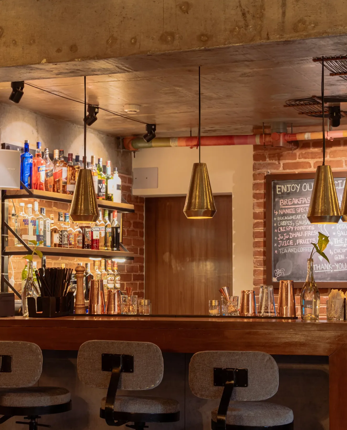 Restaurant seating with hanging lights and rustic décor at the Community Bistro.