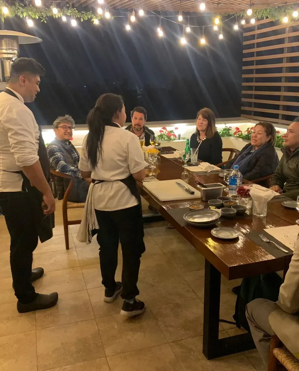 Guests dining on an open-air rooftop terrace.