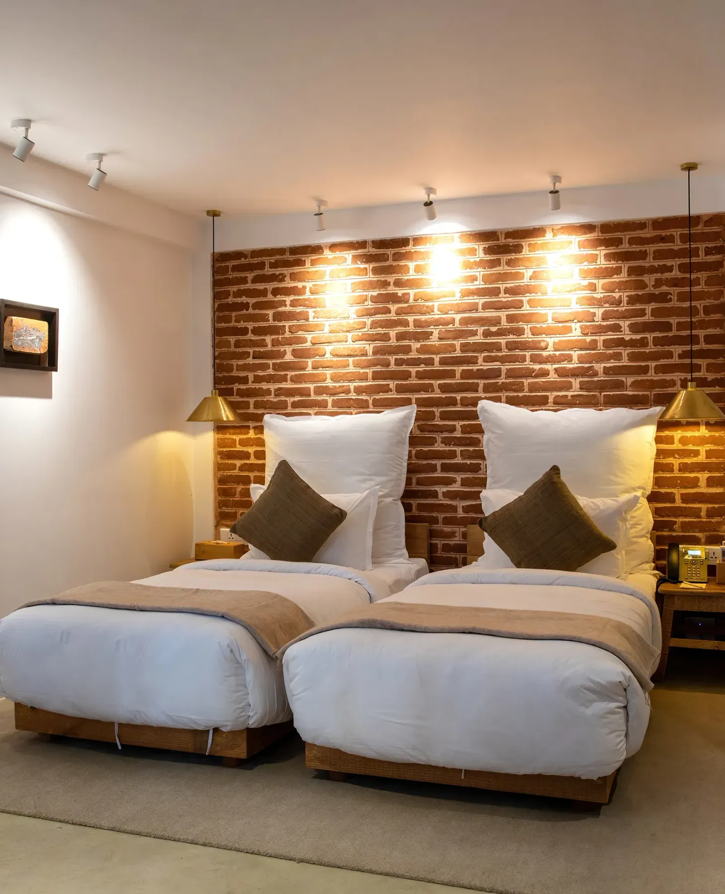 The Prithvi room with twin beds and wall art.