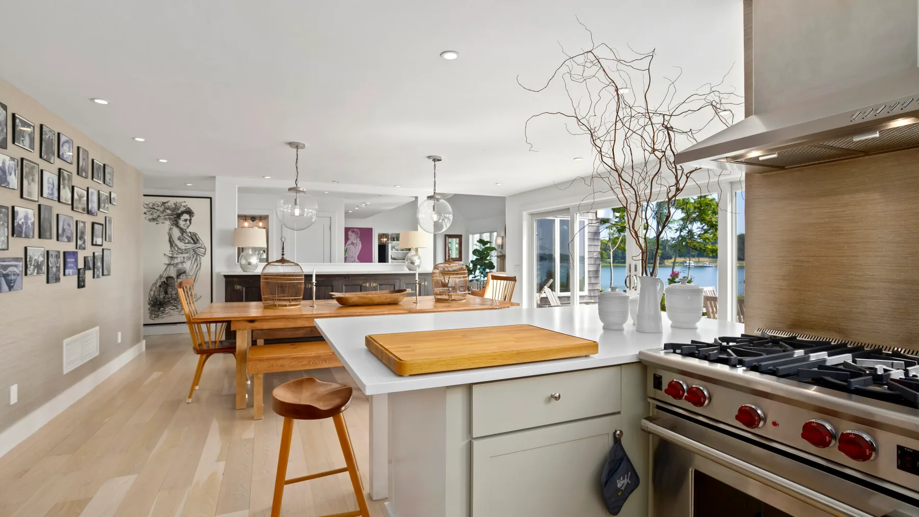 An open-plan kitchen and dining area with a large island and wooden table.