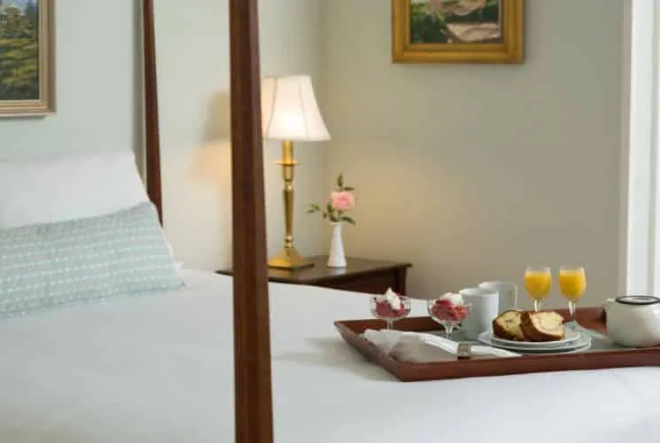 Dormitorio Barclay con cama de cuatro postes de madera oscura