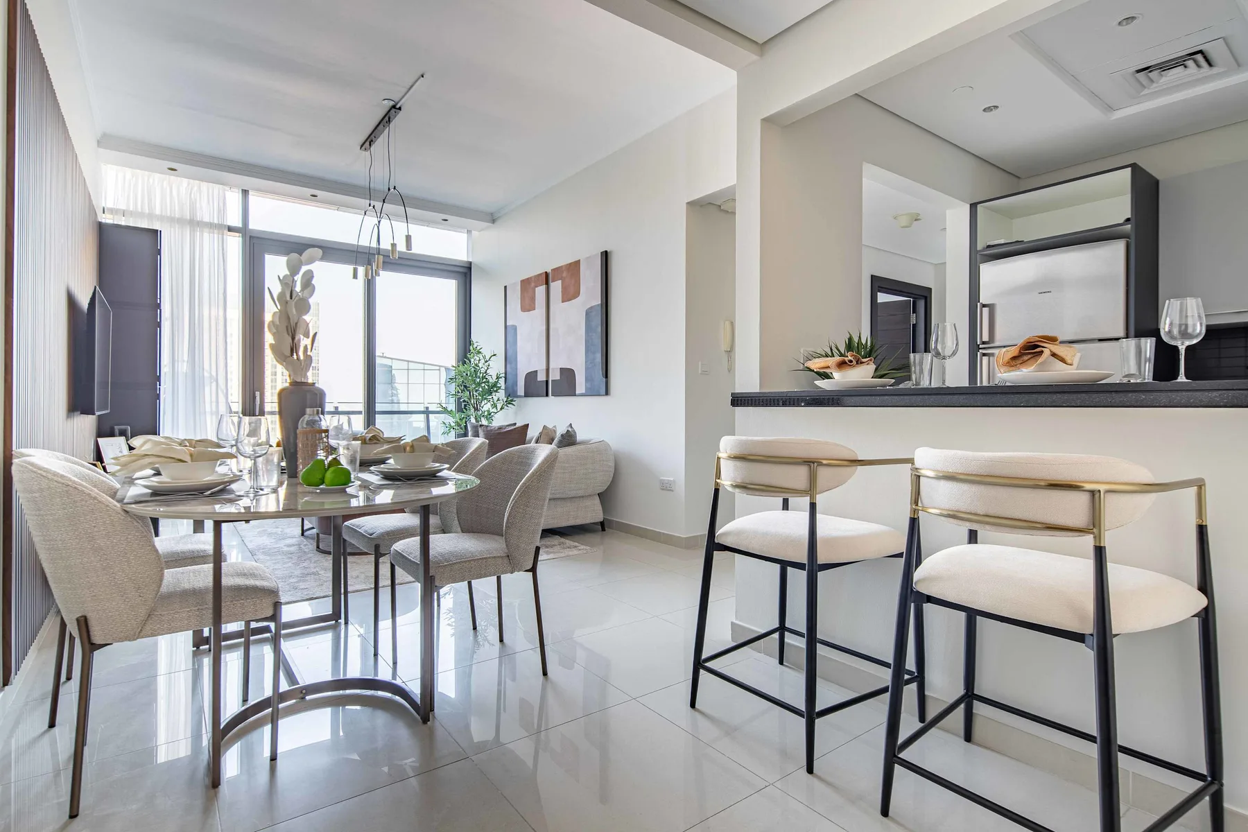 A bright dining area with a set table and a breakfast counter.
