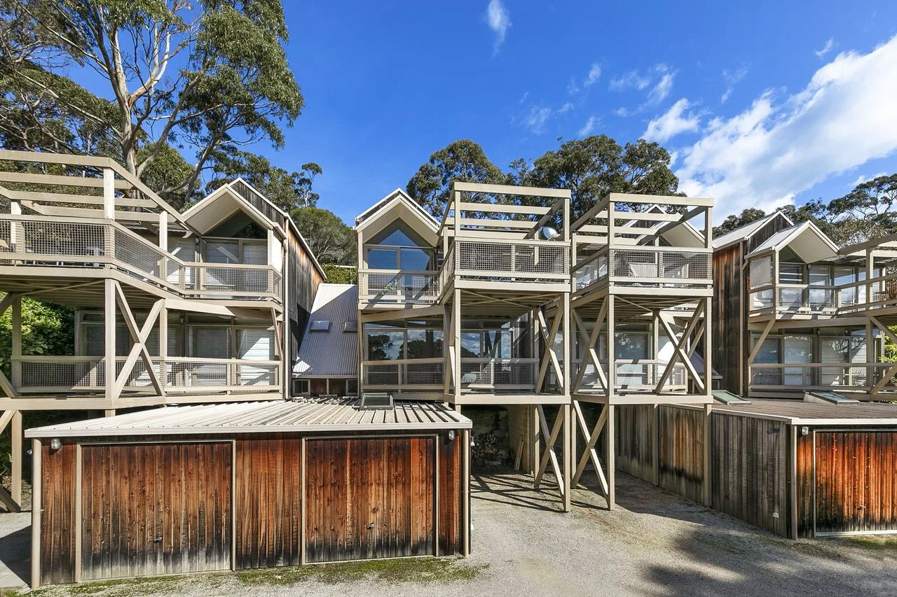 A multi-level lodge complex with timber balconies and exterior stairways.