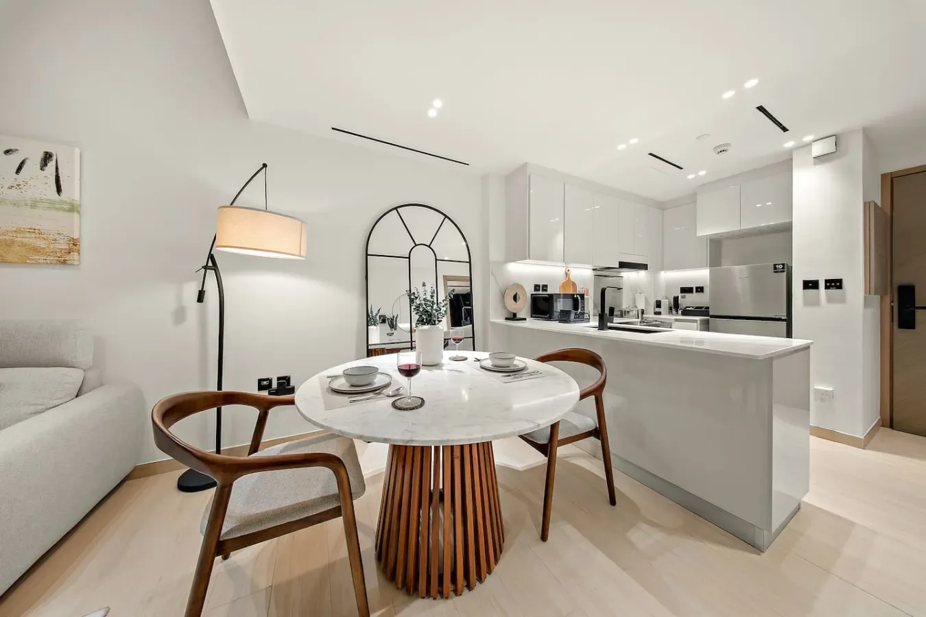 Una luminosa sala de estar de concepto abierto con mesa de comedor y cocina.