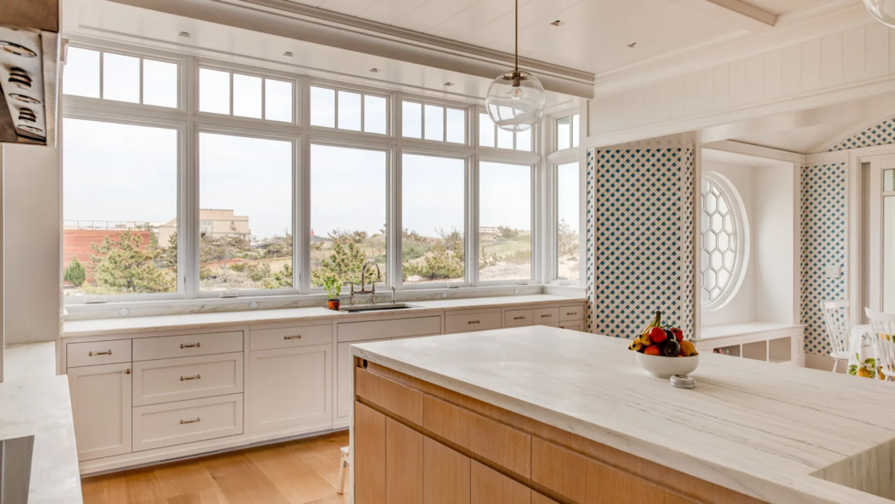 Una cocina luminosa con amplias ventanas y una isla grande.