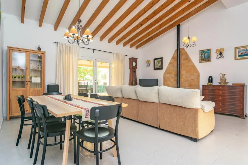 A living and dining room with a large seating area and a dining table.