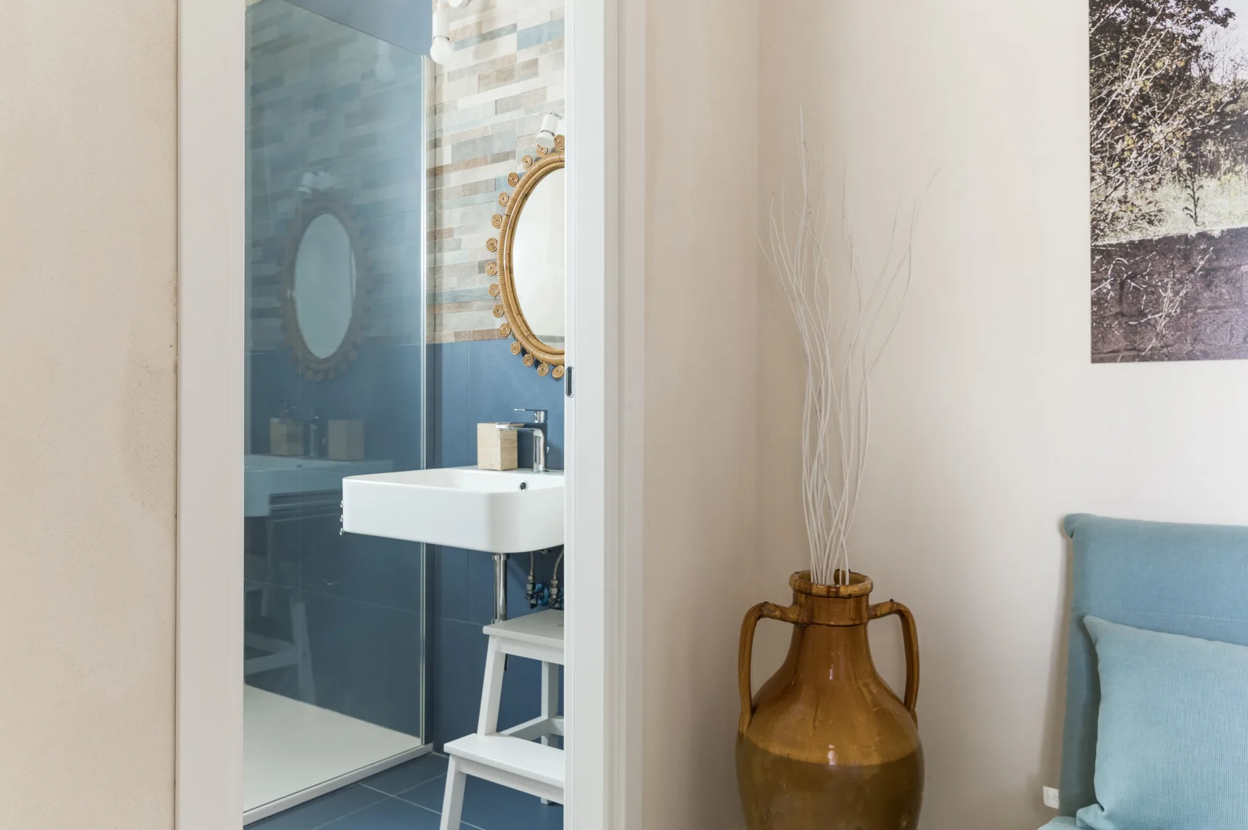 A bathroom with a glass shower and a white sink.