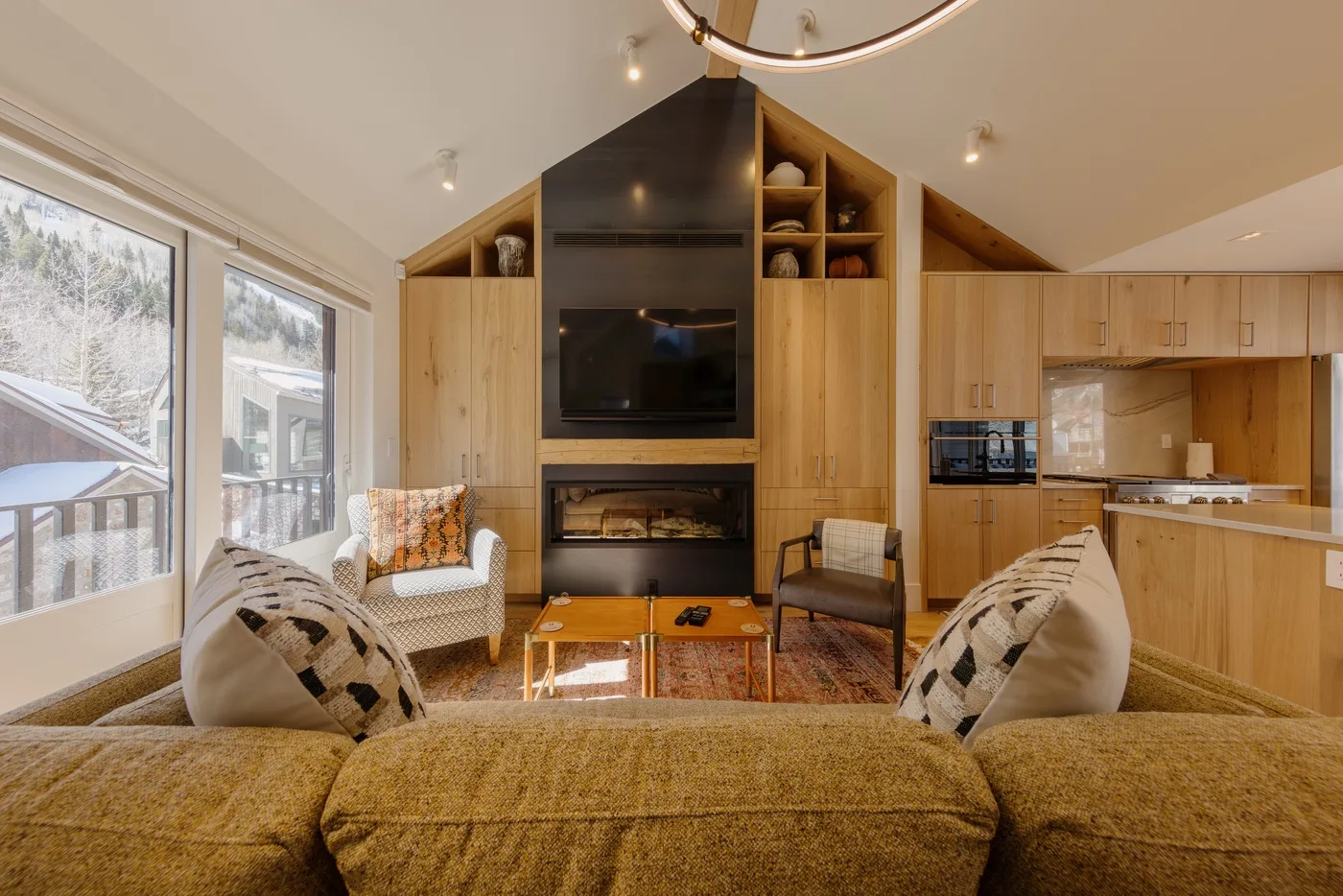 A living room with a wood-paneled entertainment wall and seating.