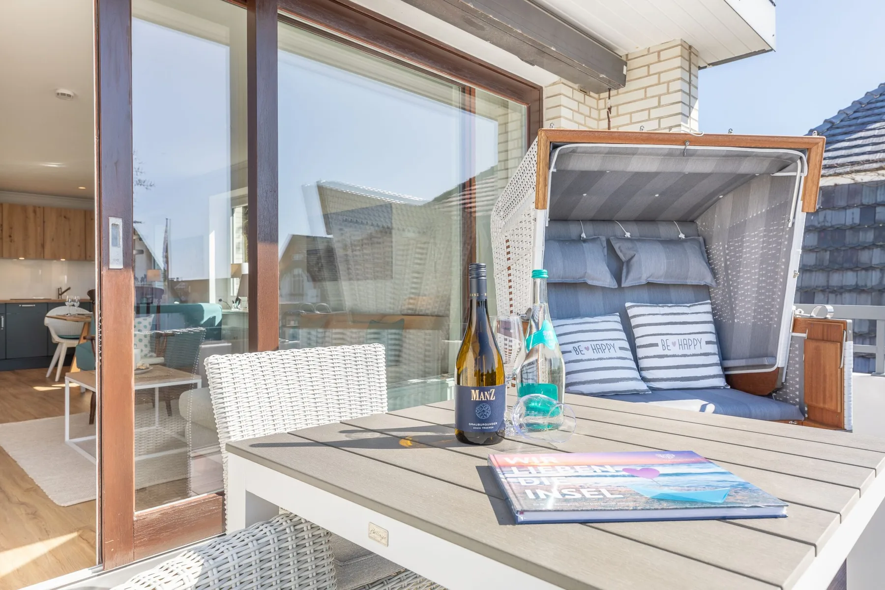 A furnished terrace dining area with a cushioned outdoor seating nook.