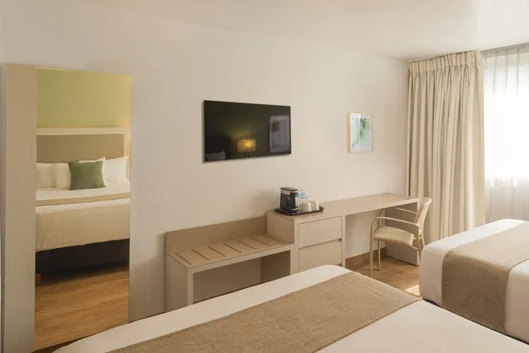 Desk, television and coffee maker in a Stanza Hotel double room