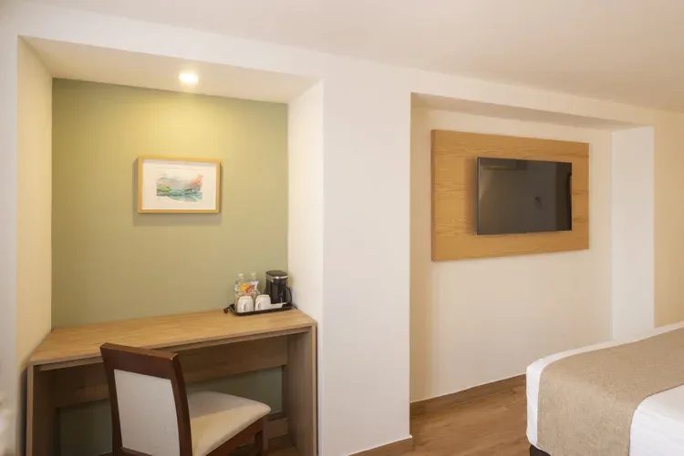 Desk, coffee maker and television in a Stanza Hotel single room