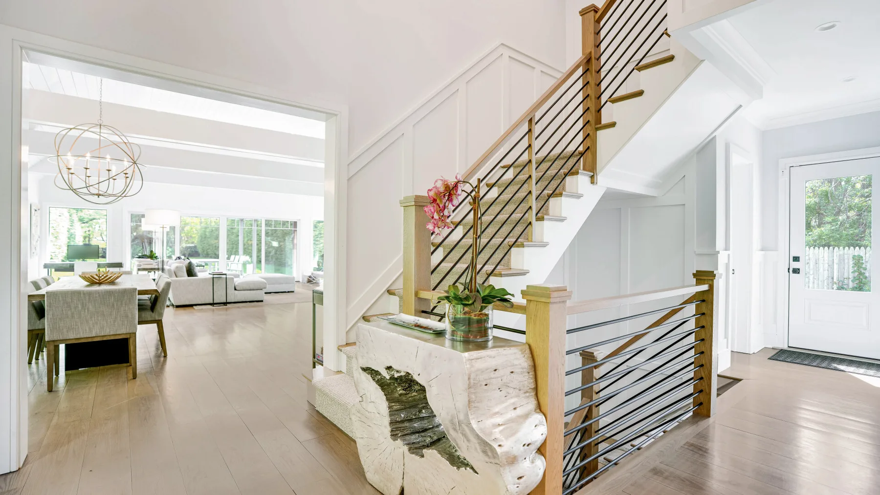 A bright open interior with a staircase beside a living area.