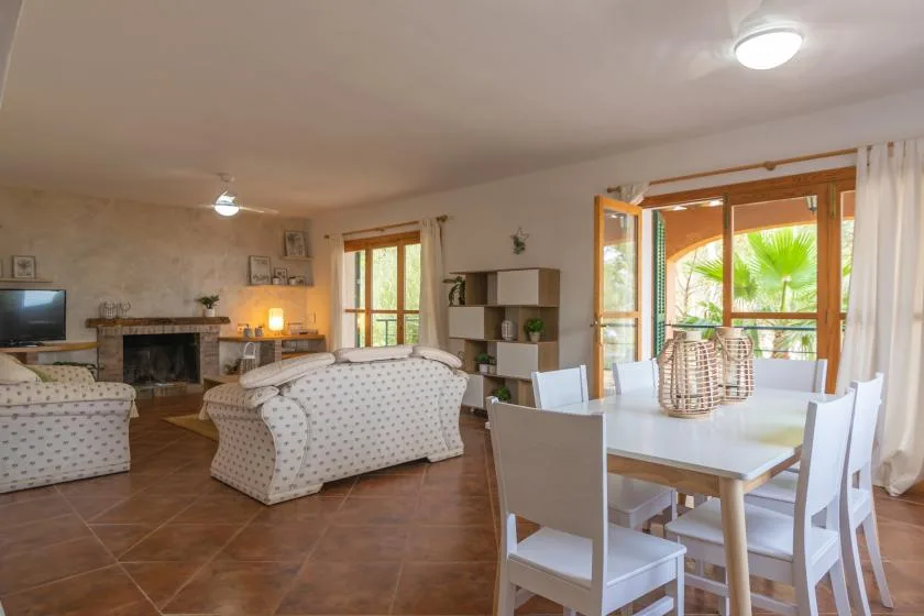 A living and dining room with seating, a table, and large windows.