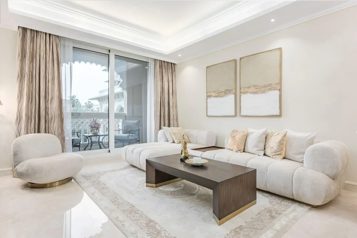 A bright living room with pale seating and a dark coffee table.