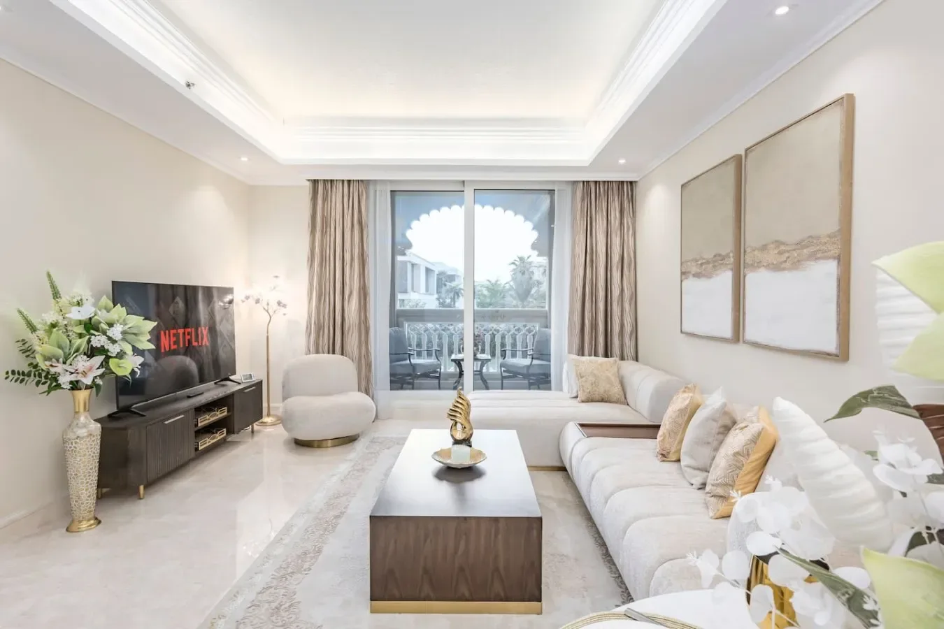 A bright living room with seating arranged around a coffee table.