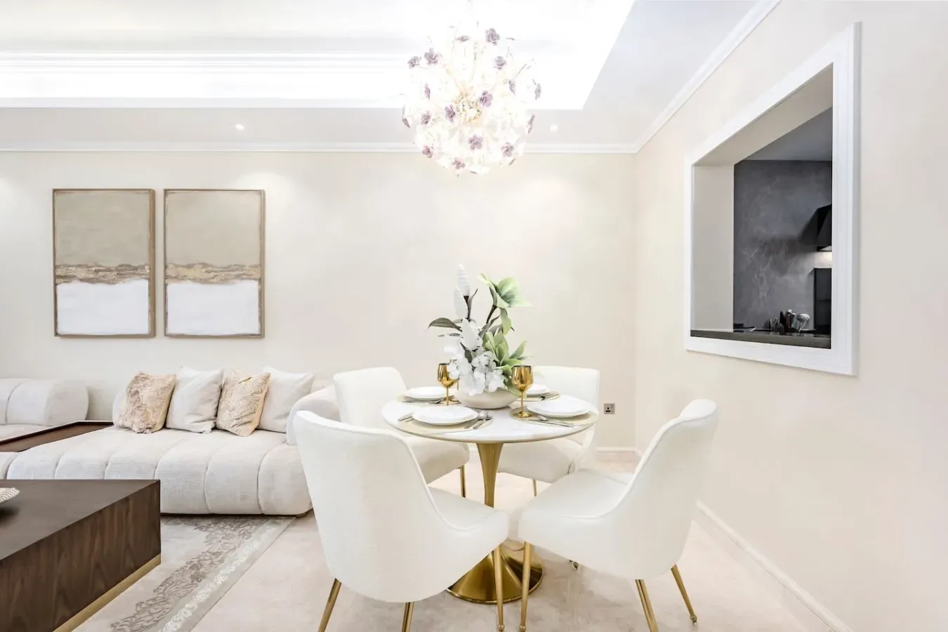 A bright living room with a sofa and a round dining table.
