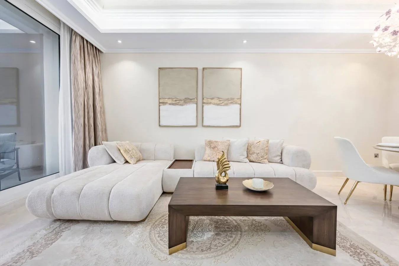A bright living room with a sectional seating area and a dark coffee table.