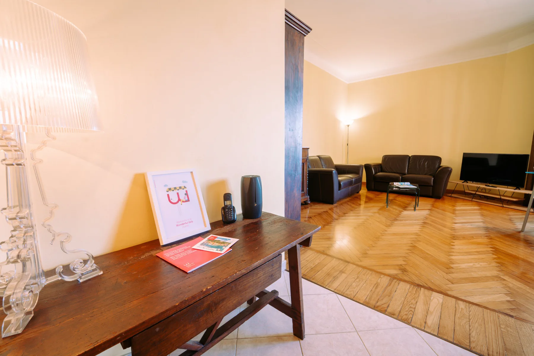 A living room with seating, a coffee table, and a television.