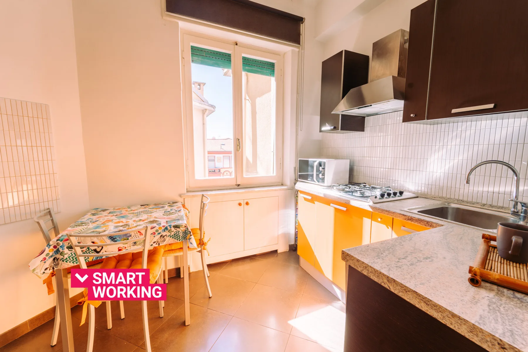 A bright kitchen with a dining table beside the window.