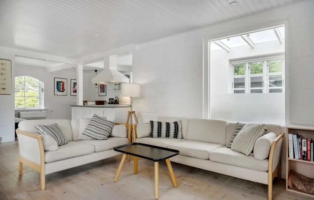 A bright living room with an L-shaped seating area and a low coffee table.