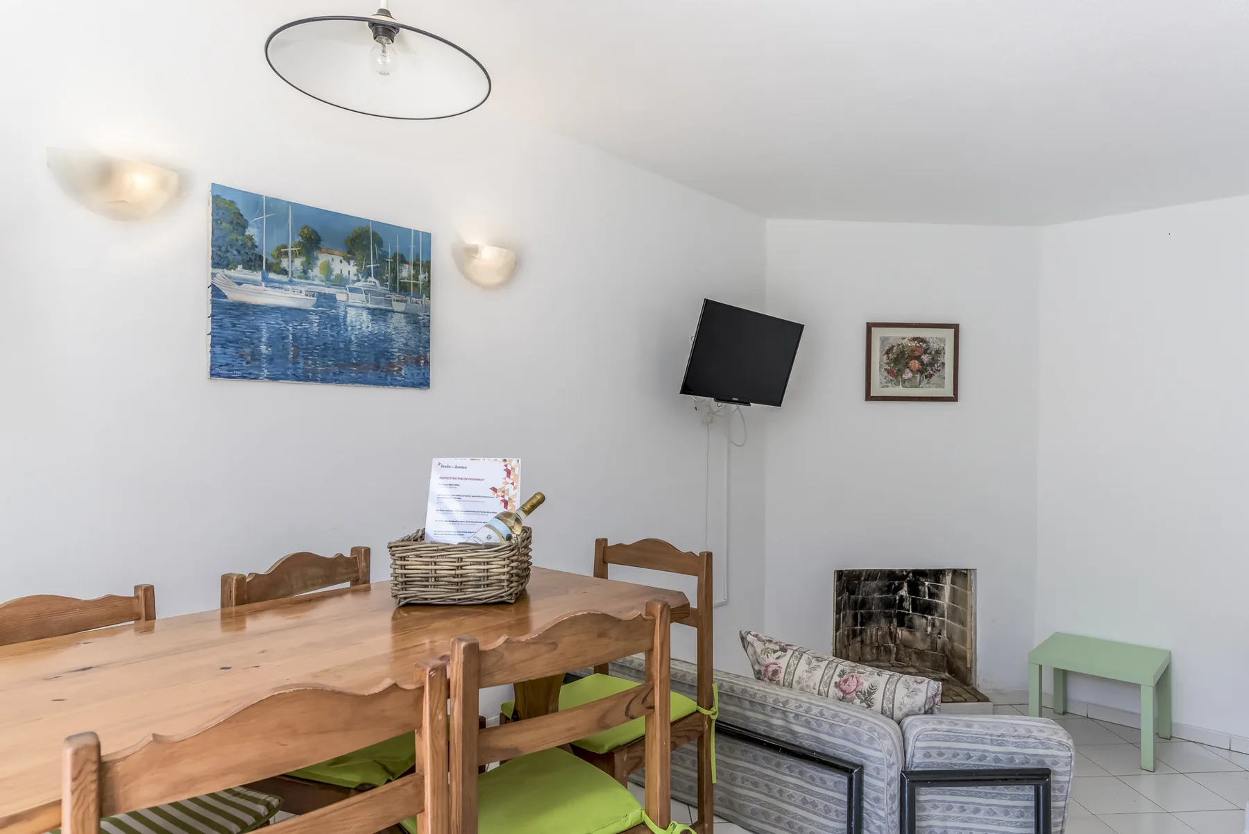 A dining area with wooden seating and a television mounted on the wall.