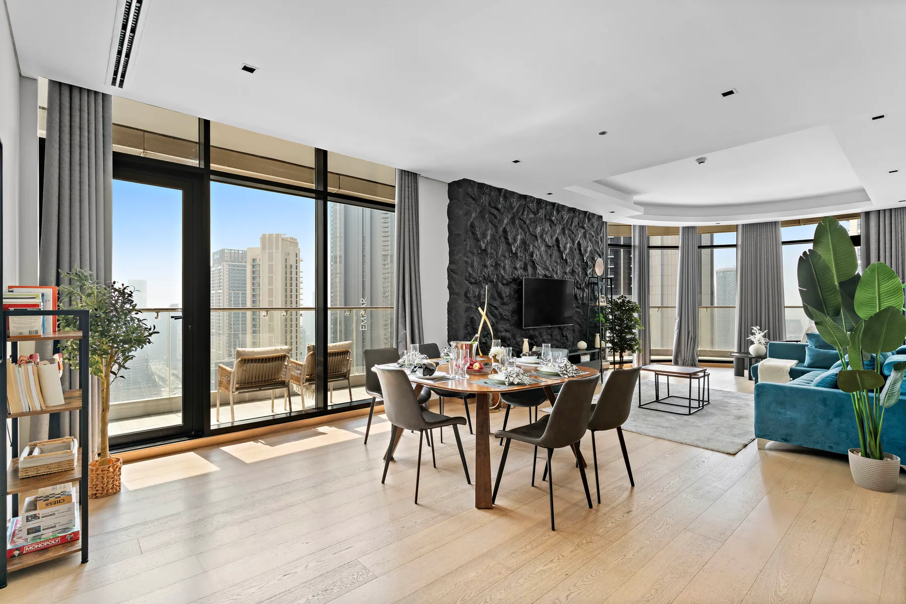 A bright open-plan living and dining area with floor-to-ceiling windows.