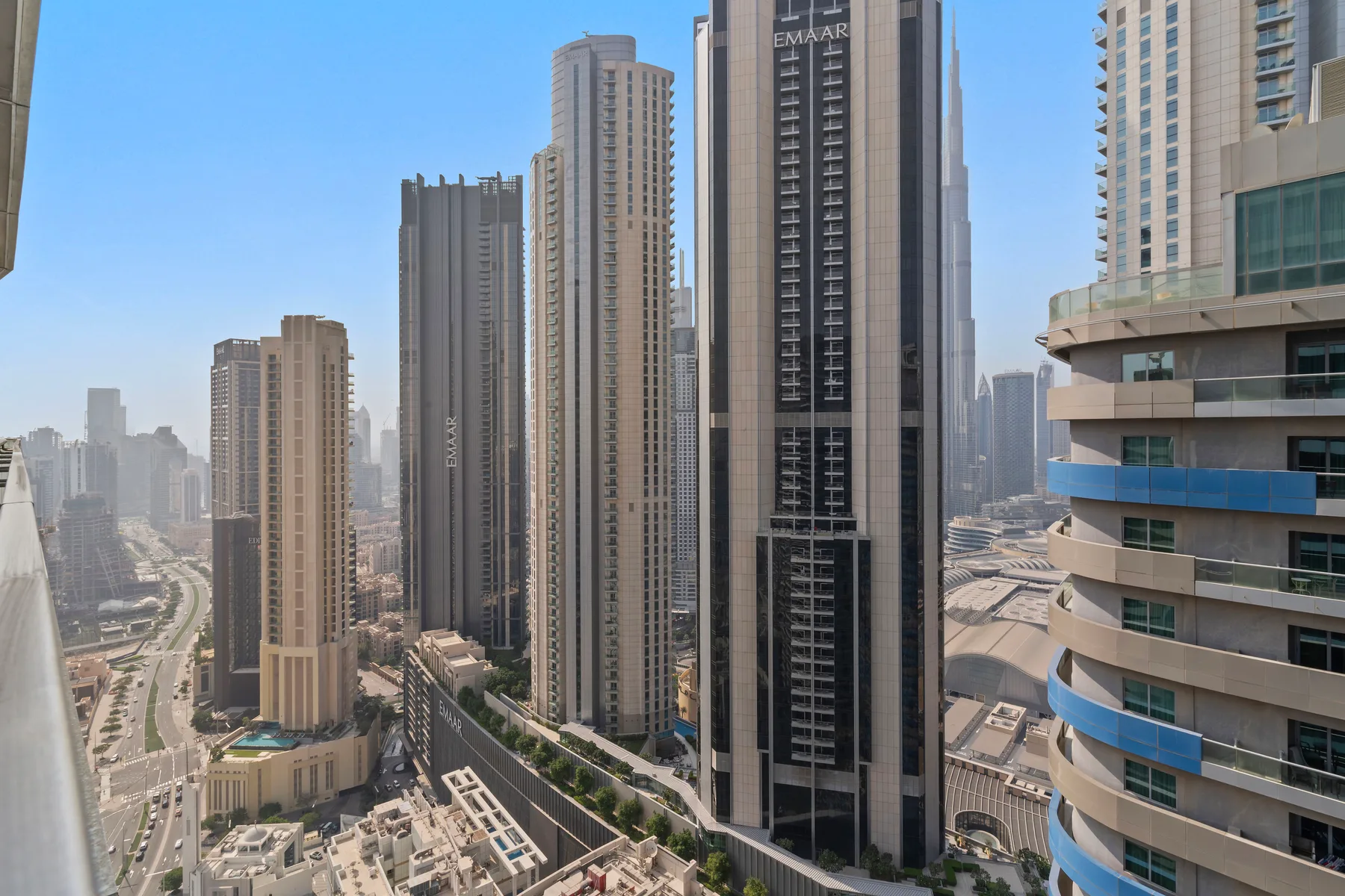 City skyline with tall buildings and roads visible below.