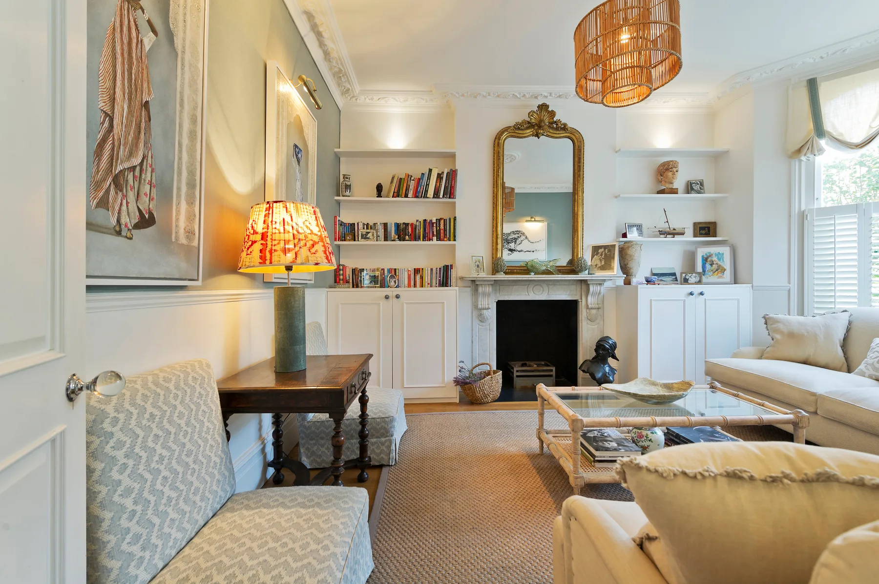 A bright living room with built-in bookshelves, a fireplace, and seating.