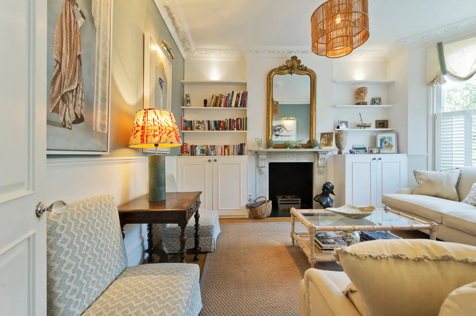 A bright living room with built-in shelves and a fireplace.