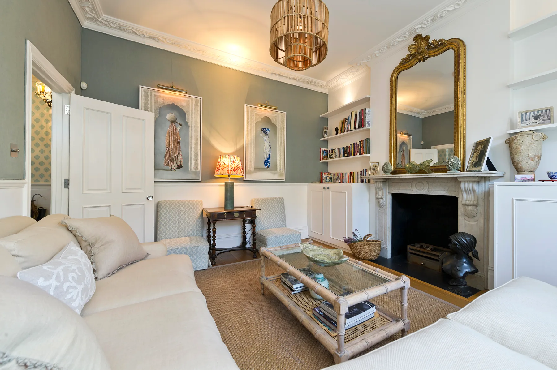 A living room with seating, a fireplace, and a coffee table.