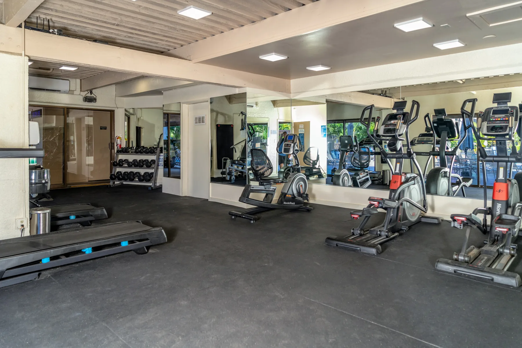 A gym with treadmills and other exercise equipment.
