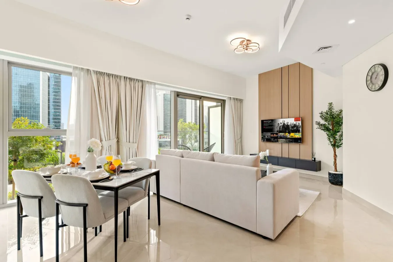A bright living room with a dining table beside the seating area.