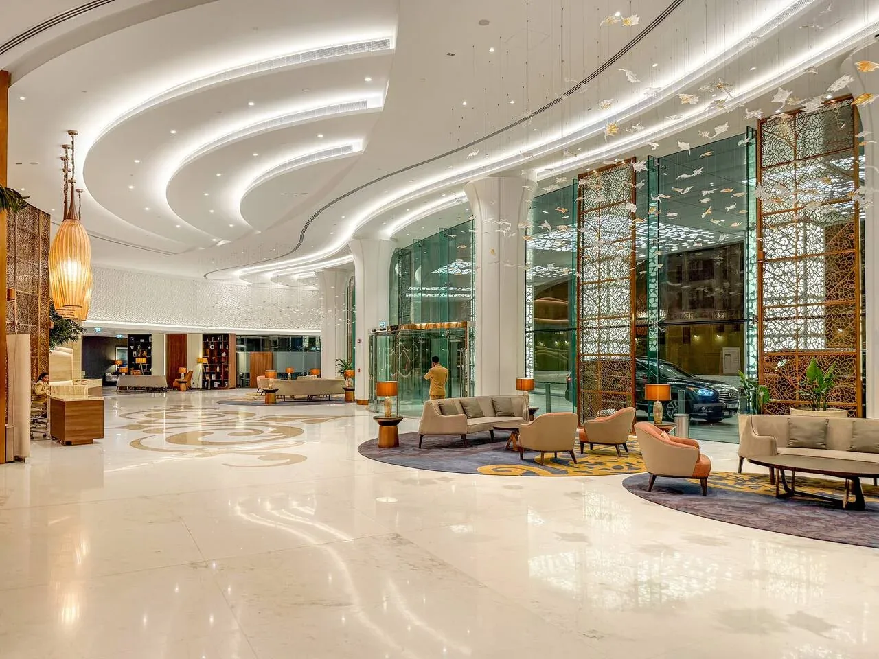 A spacious lobby with seating areas and large windows.