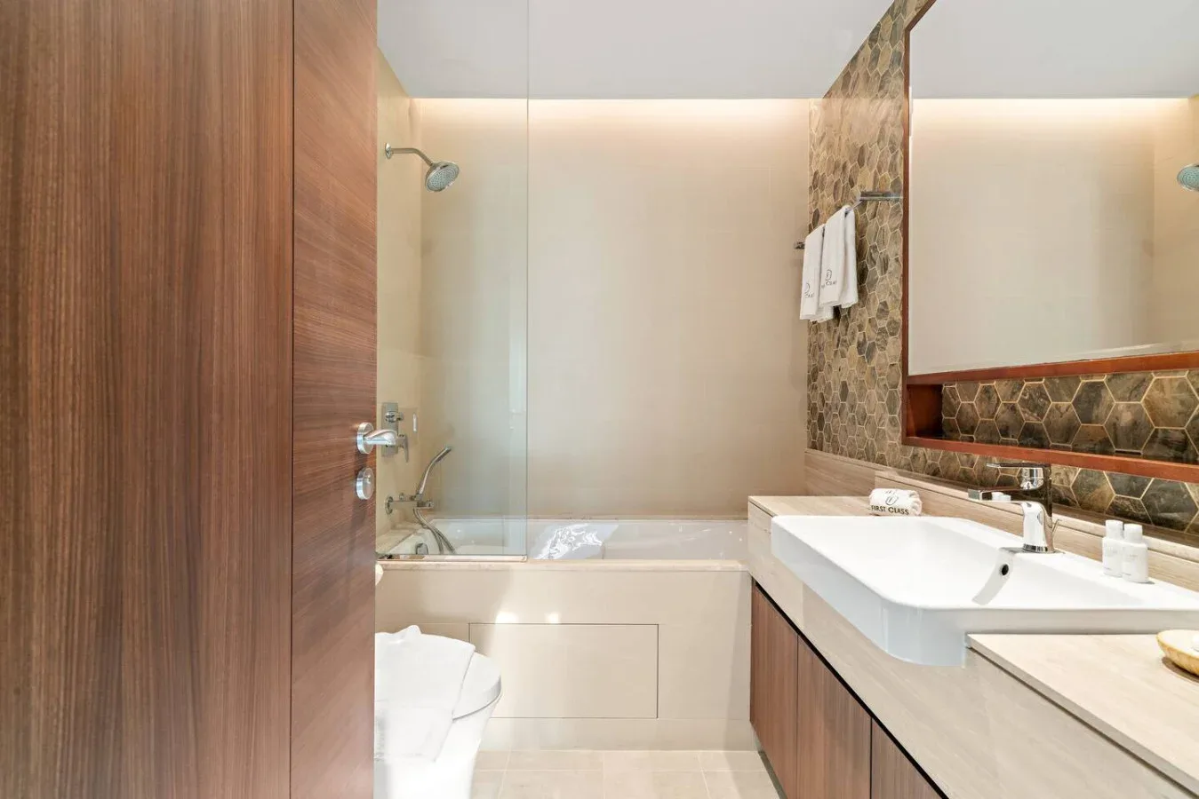 A bathroom with a bathtub, shower, and sink.
