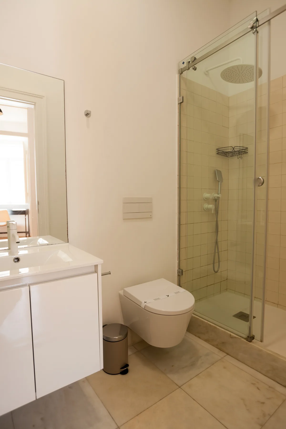 A bathroom with a sink, toilet, and glass shower.