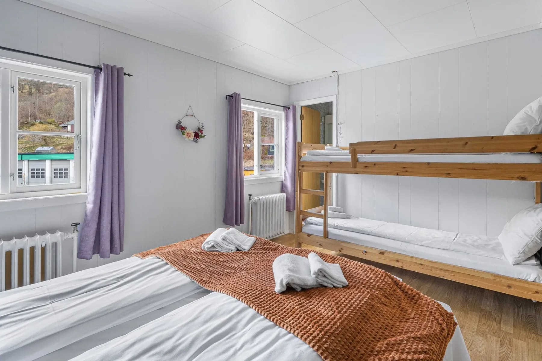 Bedroom with a bunk bed and a small window seat.