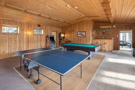 Recreation room with a ping-pong table and pool table.