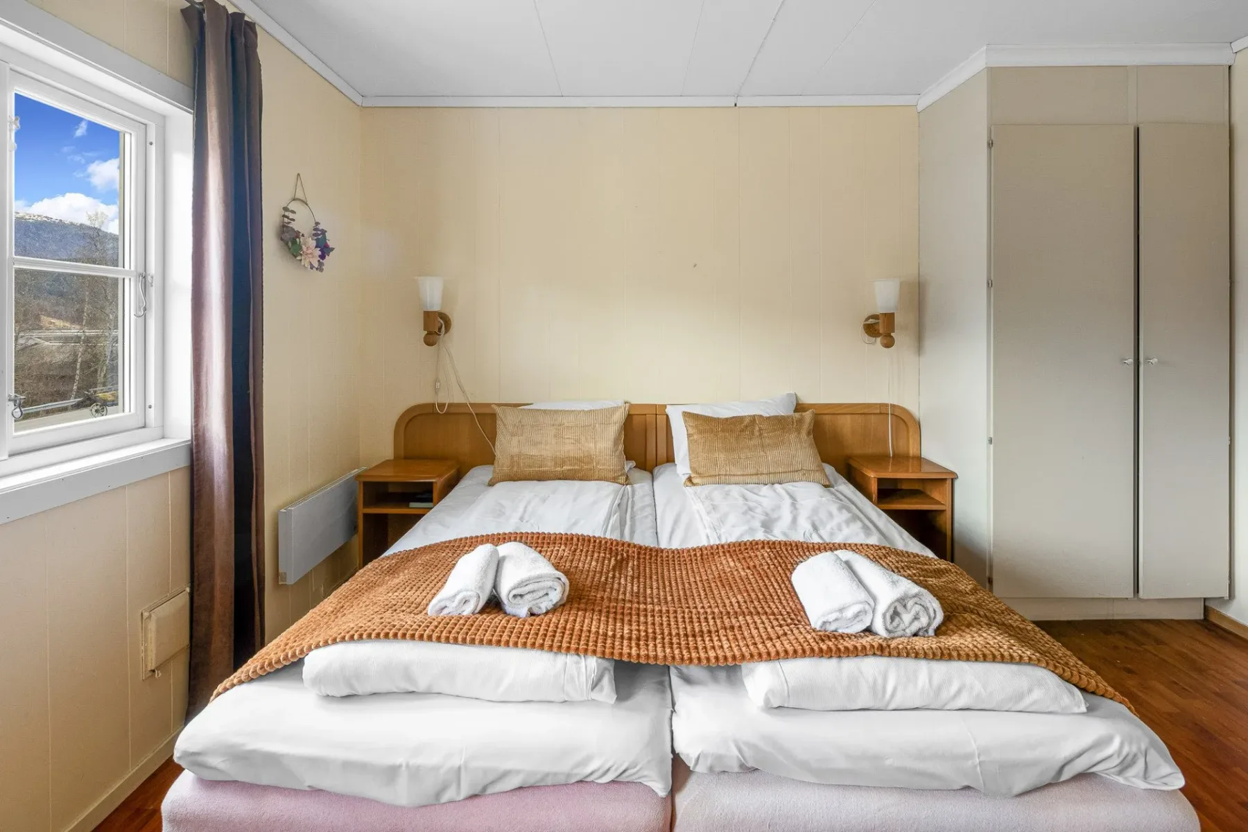 Bedroom with a bed and a large window.