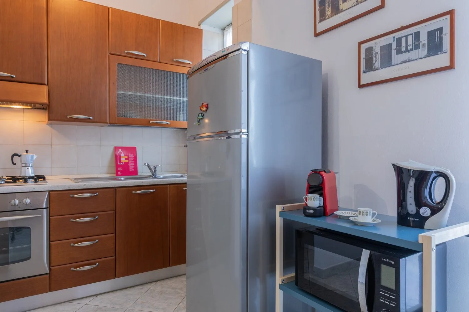 A kitchen with wooden cabinets, a refrigerator, and countertop appliances.