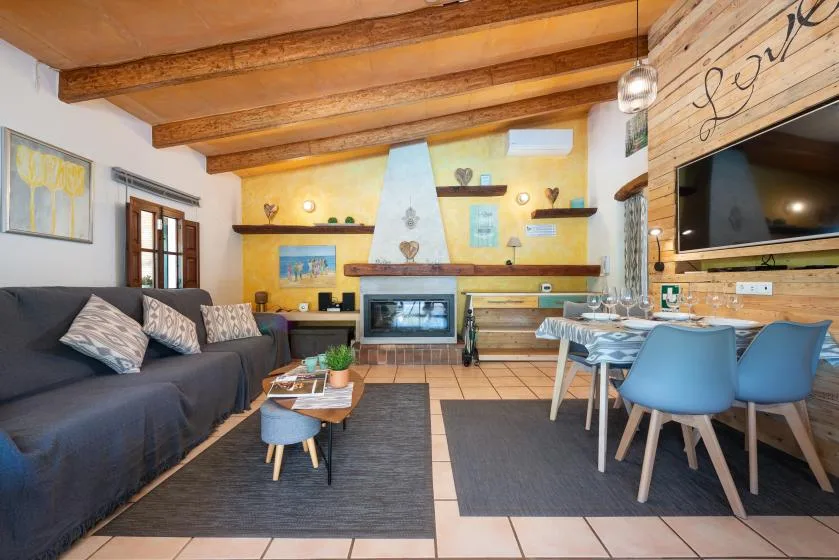 A living and dining area with seating, a table, and a fireplace.