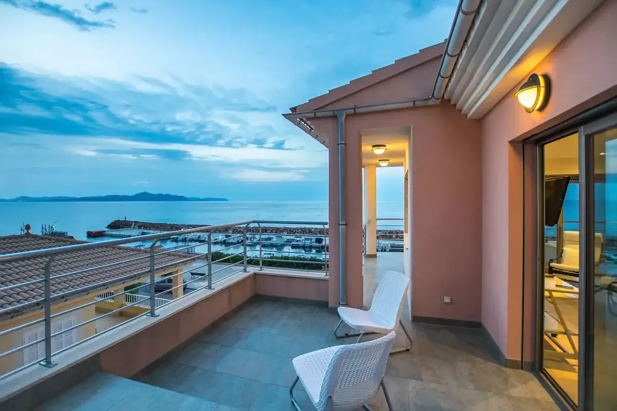 A sea-facing terrace with seating and a view across the water.