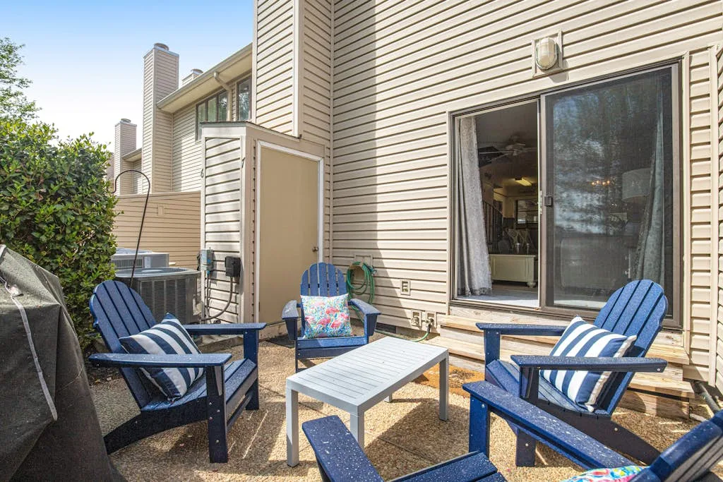 A patio with outdoor seating and a sliding glass door.