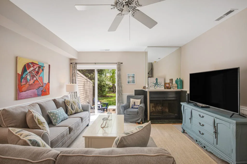 A living room with seating, a coffee table, and a television.