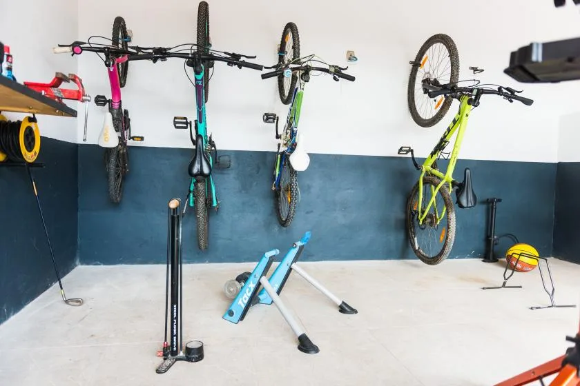 A bicycle storage area with several bicycles mounted on the wall.