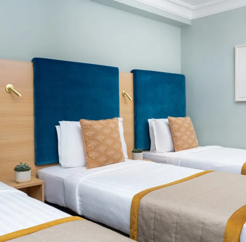 Hotel room with three single beds.