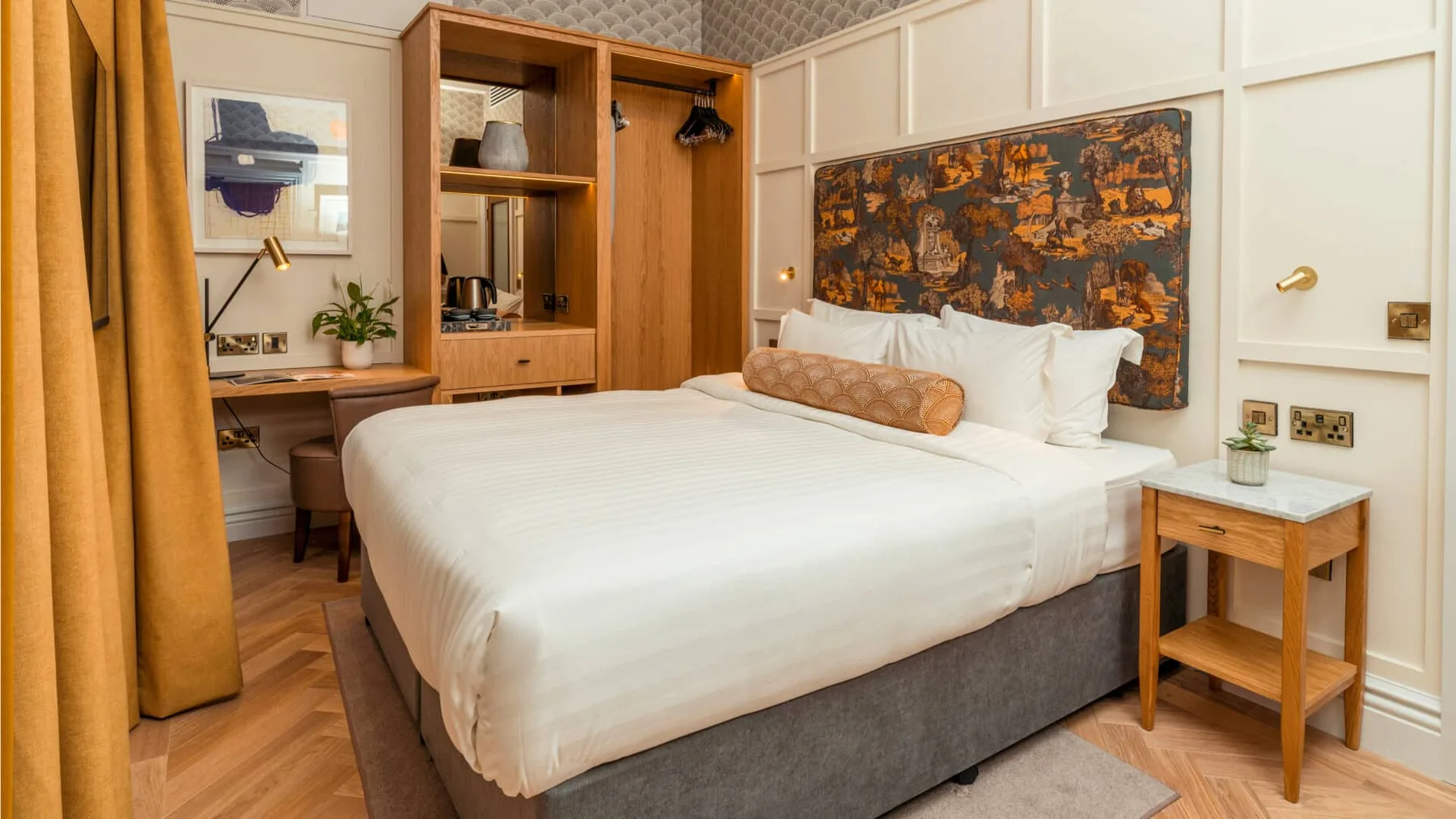 Hotel room with king-size bed and coffee station.