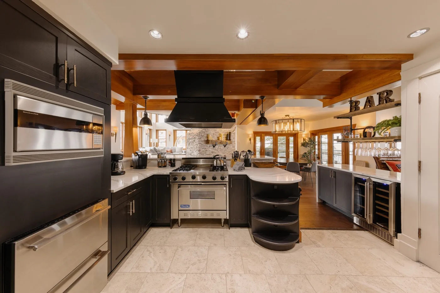 Kitchen with dark cabinetry, stainless steel appliances, and a central island.