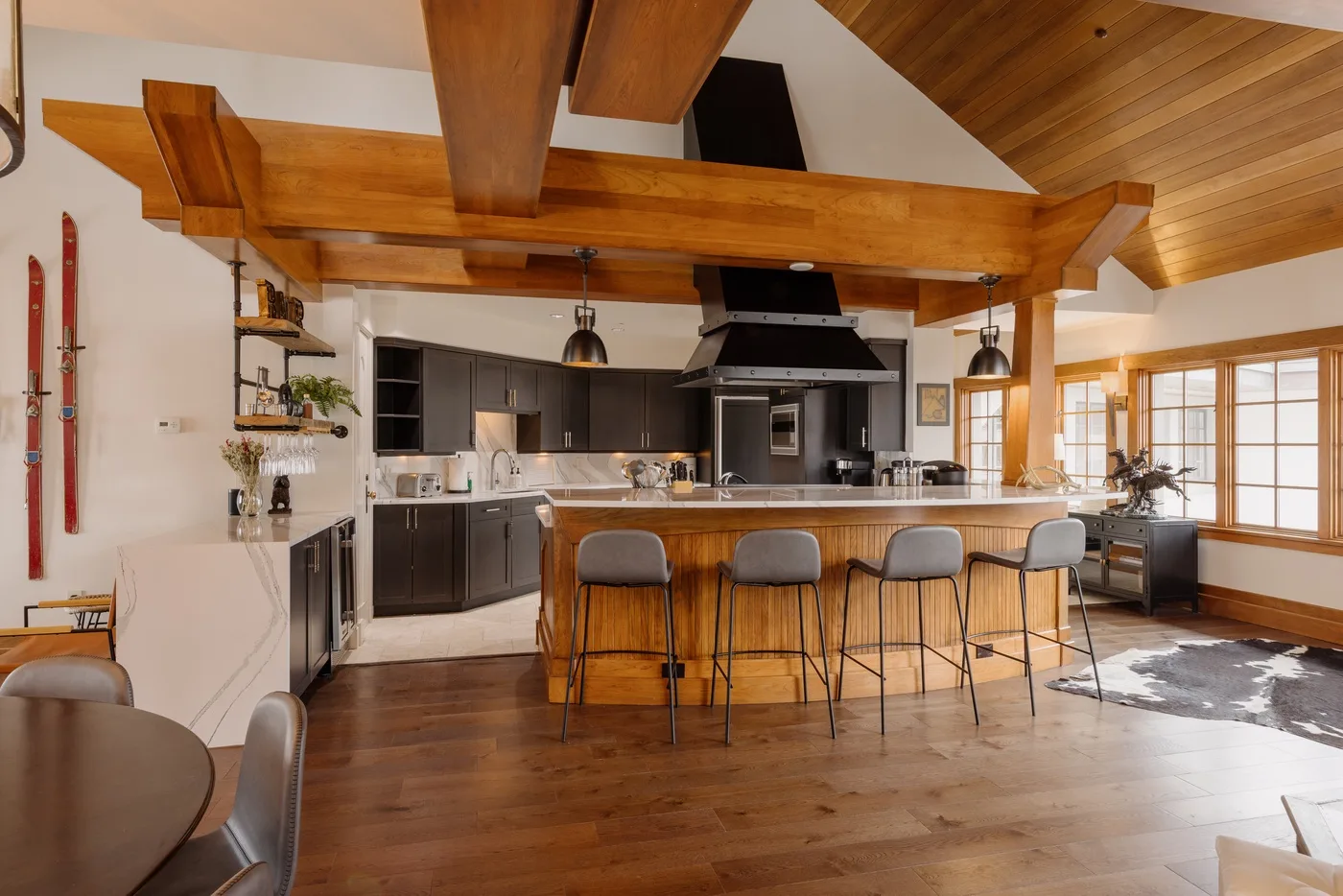 A spacious kitchen and dining area with a central island and bar seating.