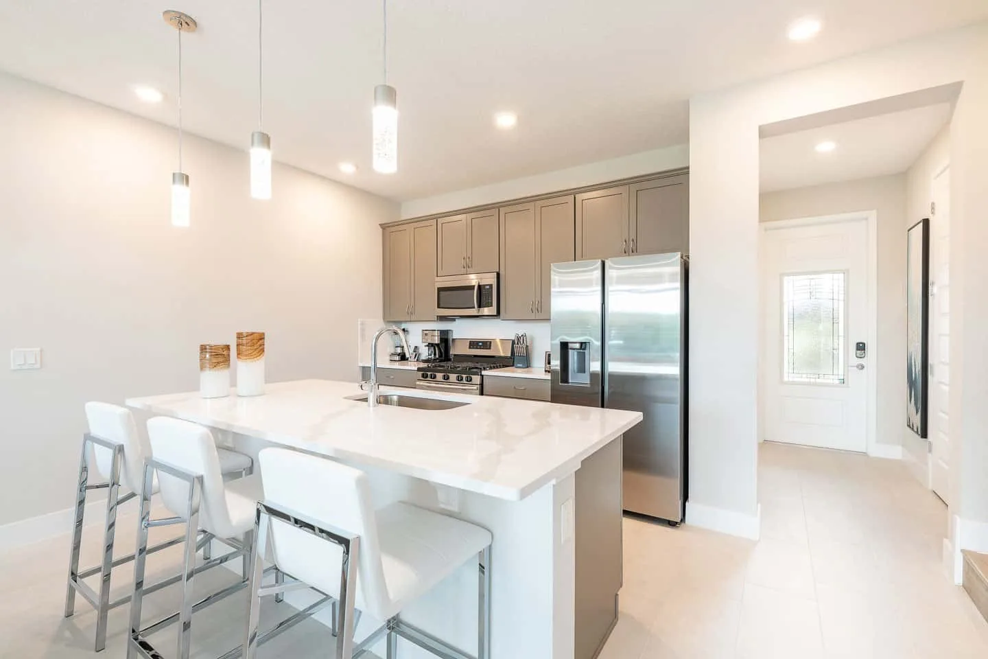 A bright kitchen with a large island and stainless steel appliances.