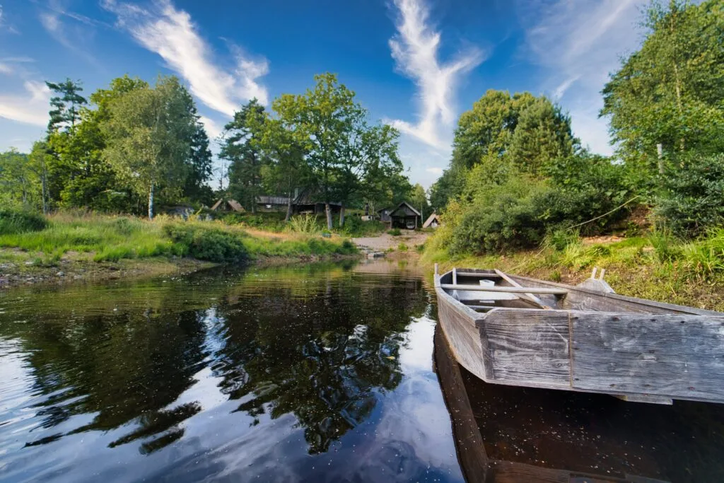 Flat-bottomed boat with the camp in the background